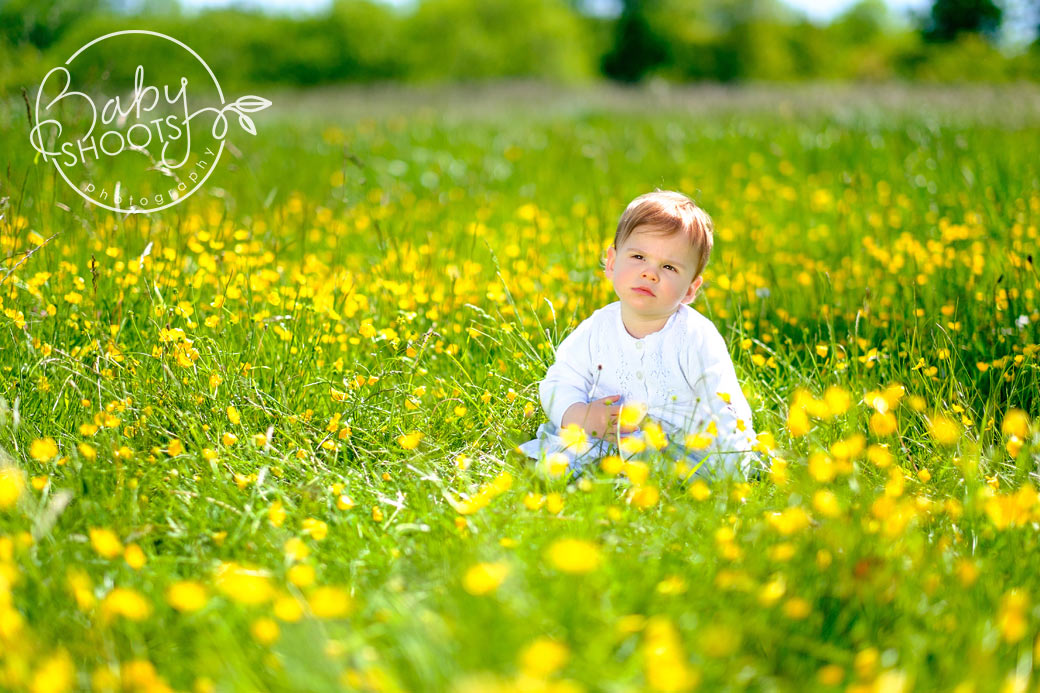 Toddler picking buttercups in the West Sussex countryside