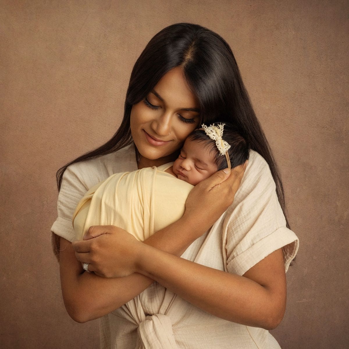 Classic newborn photography sessions for parents near Buckland Surrey. Studio portrait of new baby in Mother's arms.