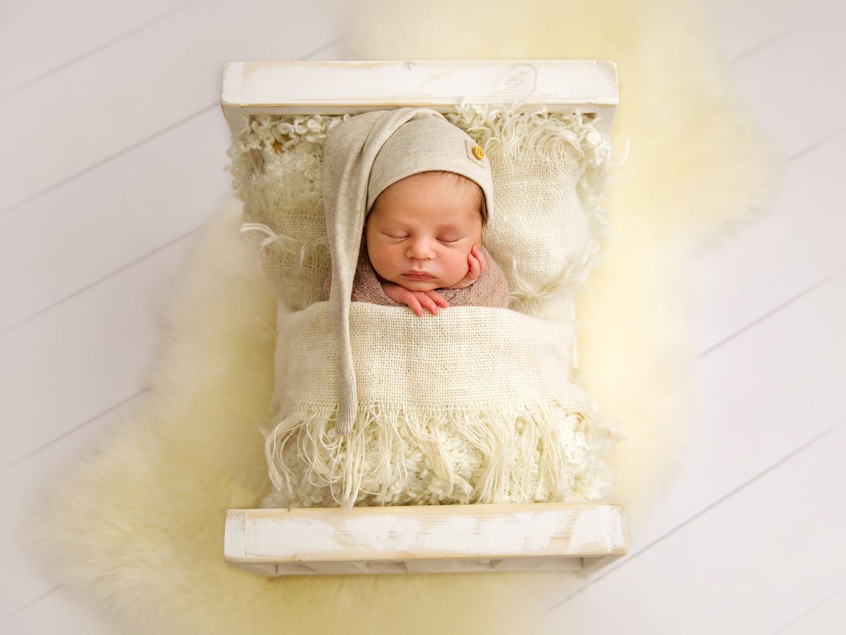 Professional newborn studio sessions for parents in South Godstone, with all bespoke props including beds, baskets bowls and accessories included in every newborn photoshoot.