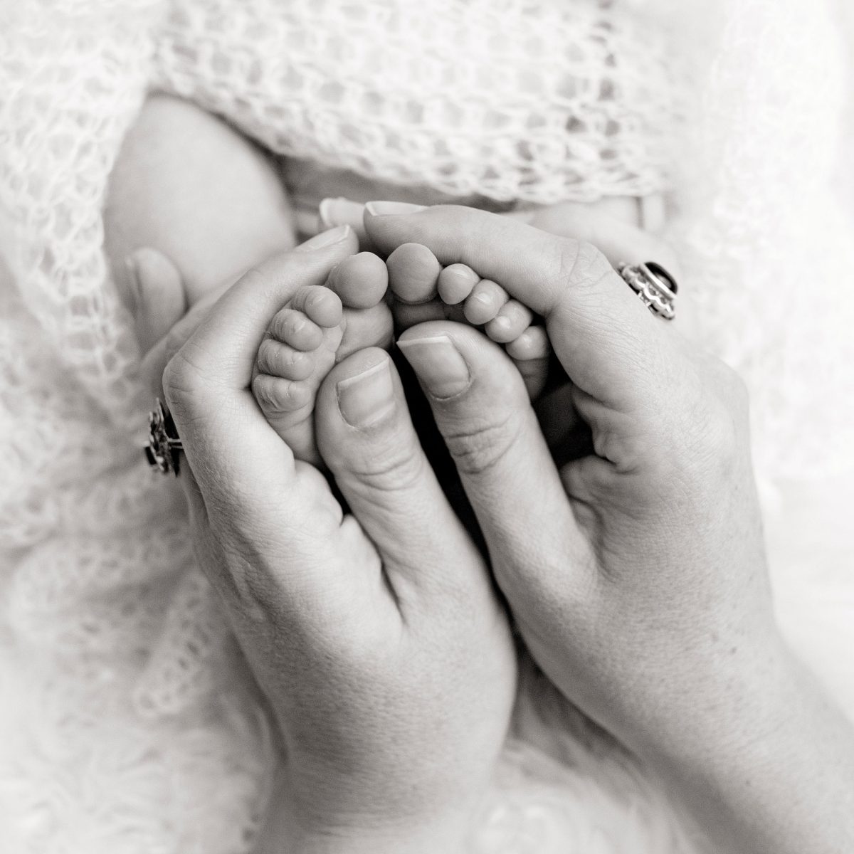 Bespoke newborn portraits for Crawley families, capturing the fine details of a newborn baby's tiny hands and feet.