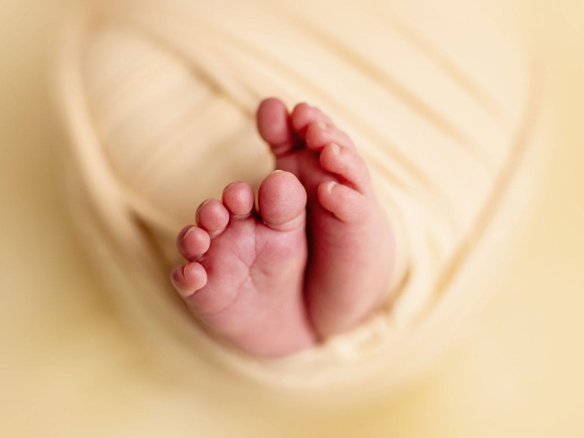 Tiny feet and toes close-up details captured during a wrapped newborn photo session in our studio in Copthorne, West Sussex.